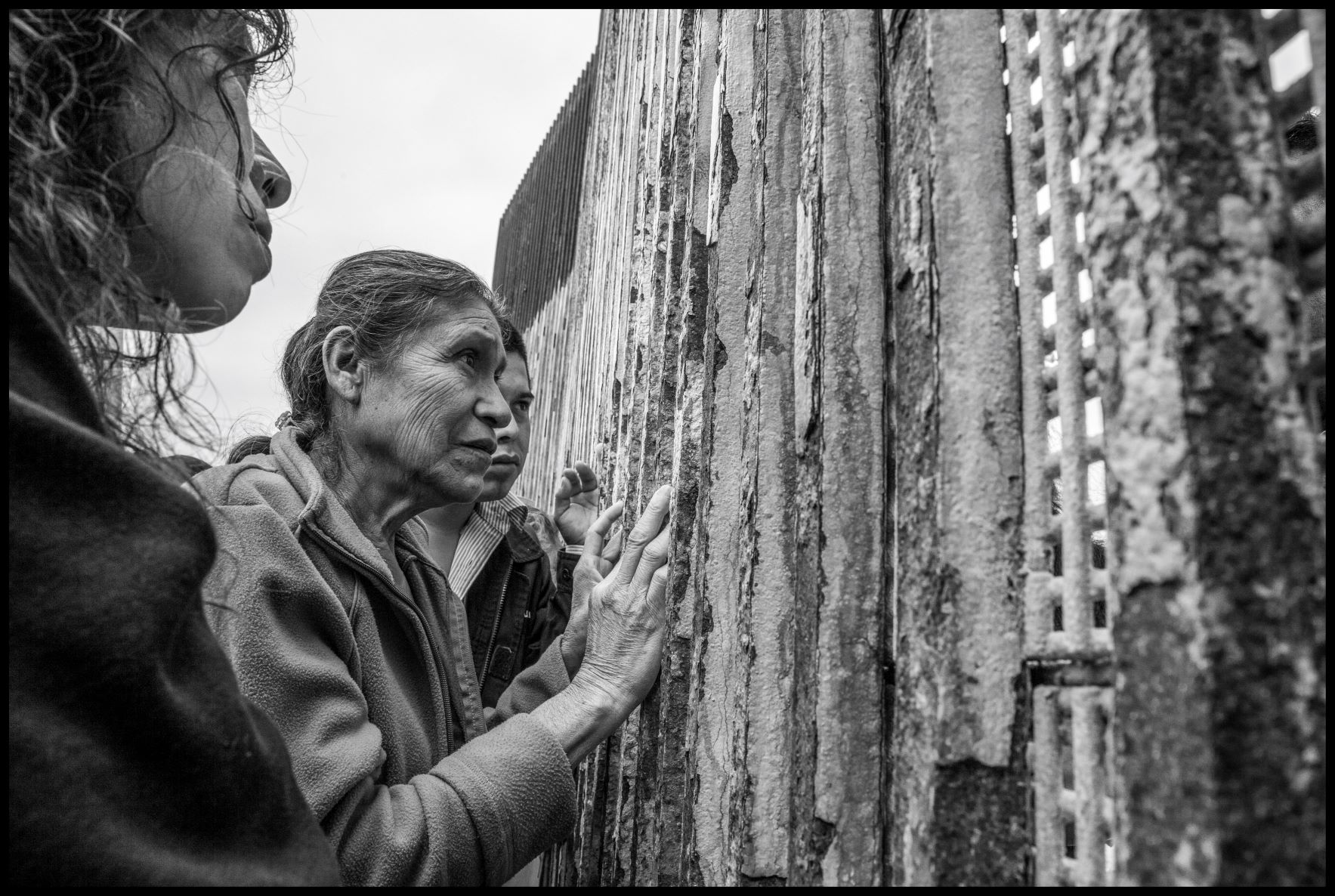 Family gathers at border wall to meet with loved ones