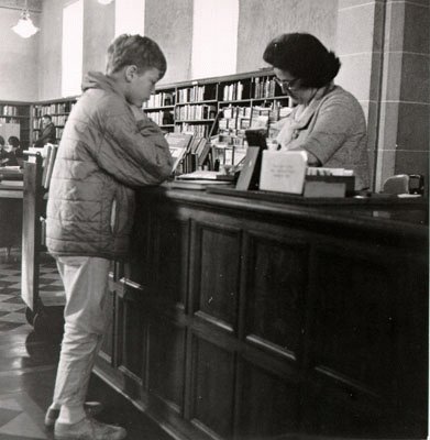 Librarian helping youth inside Anza Branch Library