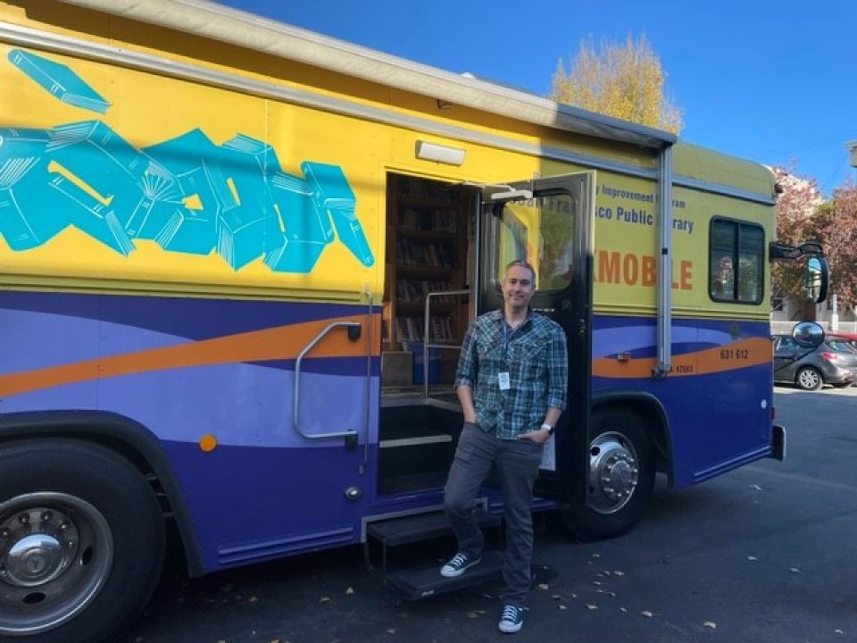 Mobile Outreach Services librarian outside Library on Wheels