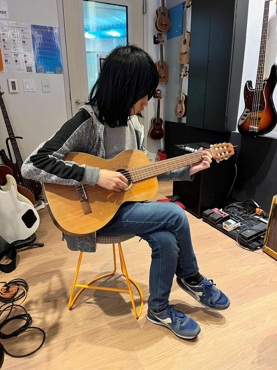 Playing guitar in the studio